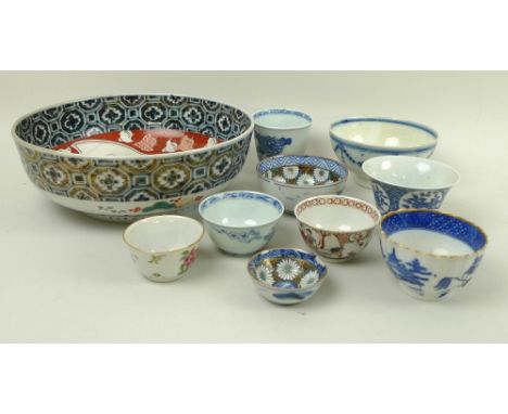 A group of Chinese and Japanese, ceramic bowls, 19th century and later, including tea bowls, one bell shaped on a high foot, 