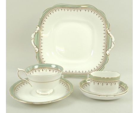 An Aynsley porcelain part dinner service, decorated with sage green bands to the rims, gilt detailing, two slightly different