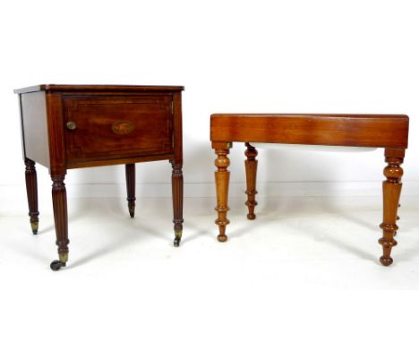 A Regency mahogany pot cupboard, with inlaid decoration to the top and the single door, raised on reeded legs and brass casto