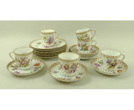 A Dresden part tea set, comprising six cups, six saucers and six small plates, all gilded and painted with sprays of meadow f