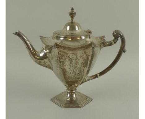 A George V silver coffee pot, of tapering hexagonal section form, with pointed corners, the lid with urn finial, foliate clas