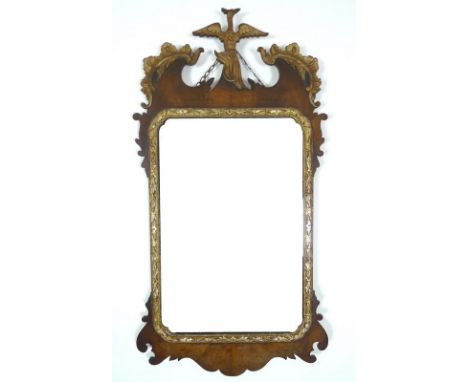 An early 19th century mahogany fret work wall mirror, scrolling foliate detailing and gilt ho ho bird finial, rectangular pla