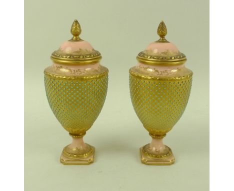 A pair of Victorian Coalport porcelain urns and covers, with pine cone finials, tapering circular section bodies, stepped squ