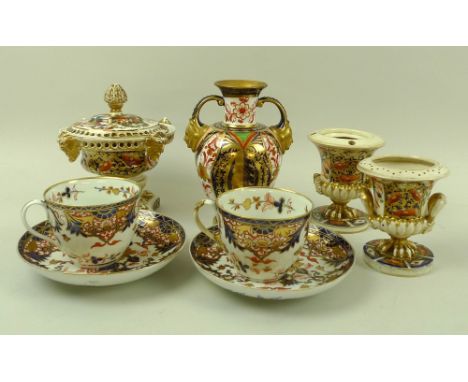 A pair of early 19th century Derby porcelain cups and saucers, decorated in the Imari pattern, one saucer unmarked, the rest 