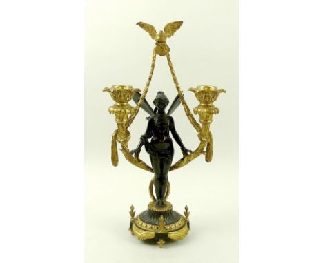 An early 20th century gilt bronze figural candlestick, modelled as a fairy or nymph standing between two sconces and with a d