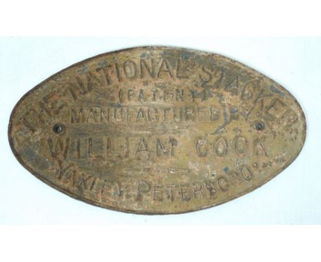 A vintage cast iron sign, of oval form with raised lettering, 'The National Stacker', by William Cook, 40.5 by 23cm.