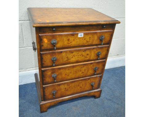 BRIGHTS OF NETTLEBED, THEODORE ALEXANDER, A BURR MAPLE BEDSIDE CHEST OF FOUR GRADUATED DRAWERS, with a brushing slide, twin m