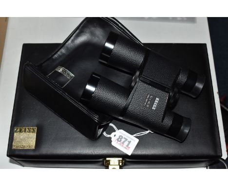 A CASED PAIR OF ZEISS 10 x 40 B BINOCULARS, in a lockable case with key, together with a leather binocular pouch and a cast m