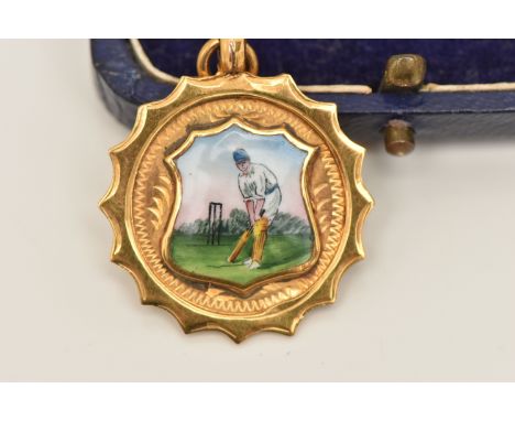 A 9CT GOLD SPORTING MEDAL, a circular form medal with a painted enamel portrait of a cricketer, approximate width 24mm, hallm