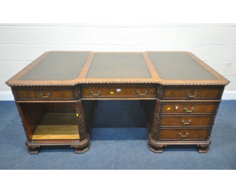 A REPRODUCTION BURR WALNUT PARTNERS DESK, with three leather writing surfaces, carved mouldings, a reverse break-front knee h