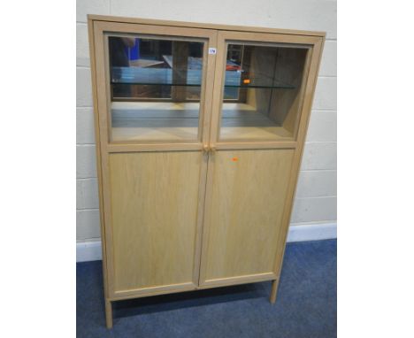 ERCOL BALLATTA, AN OAK DRINKS CABINET, with double glazed doors, that are enclosing a mirrored back, a glass shelf, a brushin