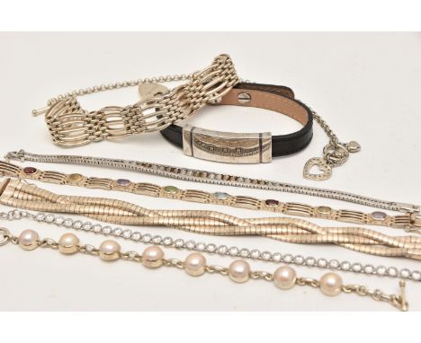 EIGHT BRACELETS, to include a  gate bracelet with heart padlock clasp, a line bracelet set with stones to include amethyst, g