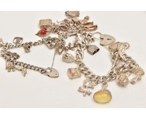 THREE CHARM BRACELETS, the first with a large curb link chain, hallmarked Birmingham, fitted with a heart  padlock clasp, fit