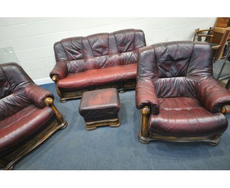 A LATE 20TH CENTURY OXBLOOD LEATHER FOUR PIECE LOUNGE SUITE, comprising a three seater 195cm x depth 96cm x height 96cm, a pa