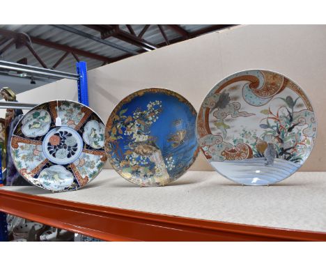 THREE ORIENTAL HAND PAINTED CHARGER PLATES, comprising an Imari style charger depicting panels of scenic views and floral des