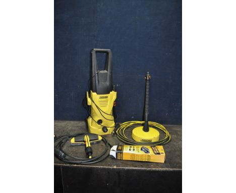 A KARCHER K2.310 PRESSURE WASHER, with lance, one nozzle, patio head, car brush, extension pipe, etc (PAT pass and working bu