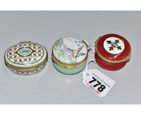 THREE ENAMELLED LIDDED TRINKET POTS comprising a '1989' Halcyon Days Enamels with a commemorative decoration inscription to t