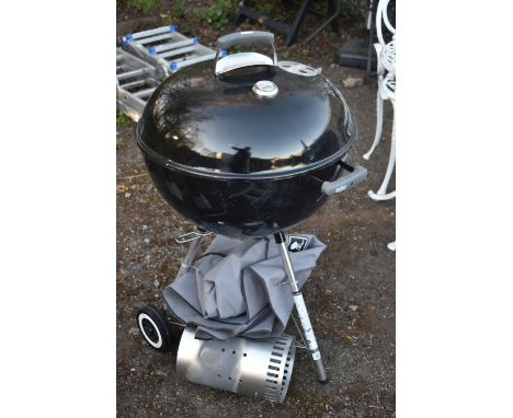 A WEBER ORIGINAL KETTLE CHARCOAL GRILL MASTER BARBEQUE, with a esscherts garden and weber tools, other accessories and a cove
