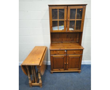A MODERN PINE DRESSER, with double glazed doors, atop a base with two drawers, over double cupboard doors, width 92cm x depth