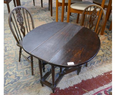 Children’s gate leg table together with pair of elm seated wheel back chairs 