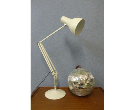 A white metal anglepoise desk lamp and a mirrored disco ball 