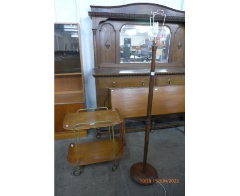 A teak standard lamp and a bent plywood and metal trolley 