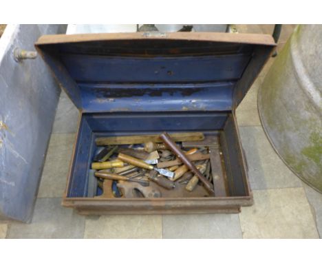 A tin trunk containing carpenter's tools 