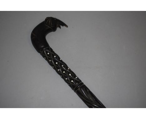 An antique ebony walking stick having carved shaft with elephant head handle 89cm long