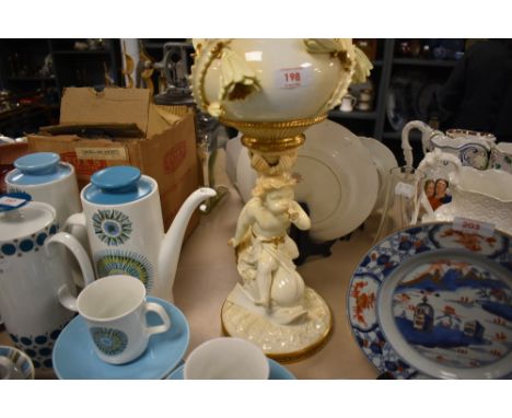 An impressive late Victorian centre piece porcelain oil lamp, having mythical fish with cherub rider below floral decorated w