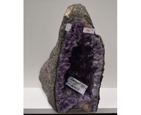 A geological rock or mineral specimen of an amethyst geode approx 55cm tall by 26cm wide