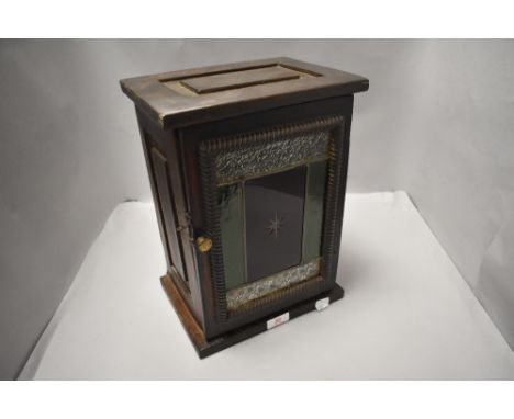 A small stained wood comunion cup cupboard, the hinged door with coloured and leaded glass panel within a moulded surround 33