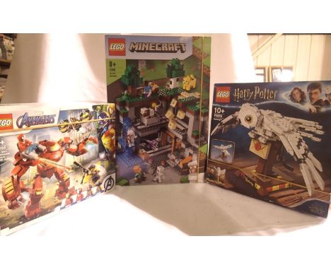 Three Lego sets to include 21169 Minecraft The First Adventure, 76164 Iron Man Hulkbuster, 75979 Harry Potter Hedwig, believe