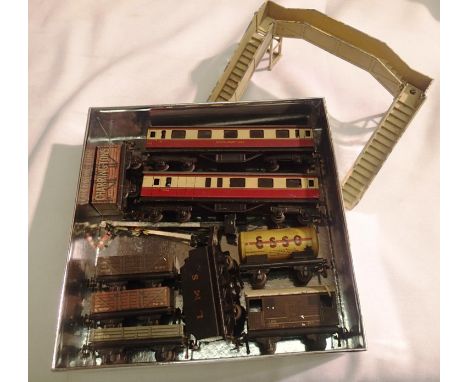 Trix twin model railway items to include two coaches, six wagons, plus black L.M.S tender. Also includes Hornby Dublo footbri