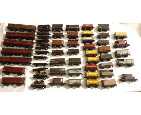 Five Hornby Dublo three rail coaches, plus fifty wagons, including S.R Brake van with sand boxes. Mostly tinplate, some fitte