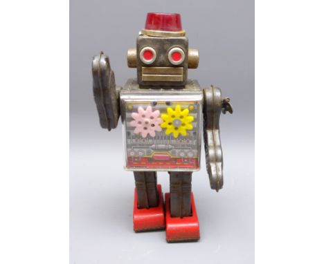 20th century Japanese clockwork grey tinplate Robot with sparking head, swinging arms, walking movement and visible torso cog