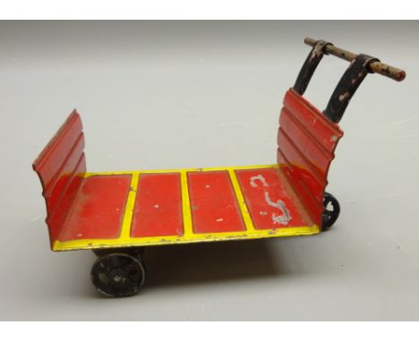Marklin tinplate 1 gauge Baggage Trolley, yellow & red body with black handle and cast black wheels, printed mark to base, L1