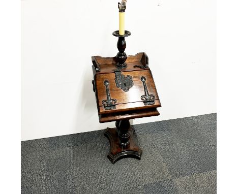 An interesting cast iron mounted wooden cabinet floor lamp, H. 123cm.