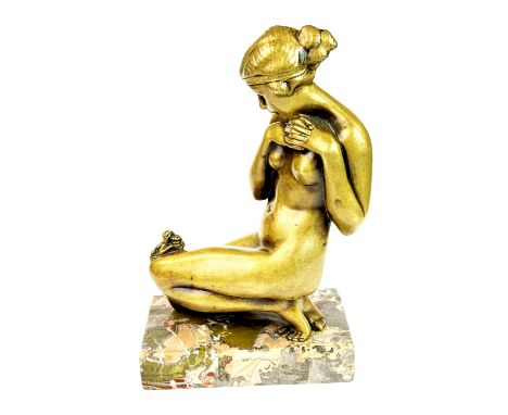 A bronze nude figure of a women with a frog resting on her knee signed Ugo Cipriani, on a marble base, H. 21cm.
