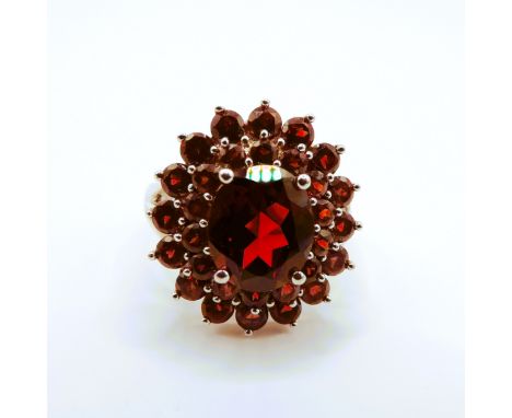 A 925 silver garnet set cluster ring, ring size P.