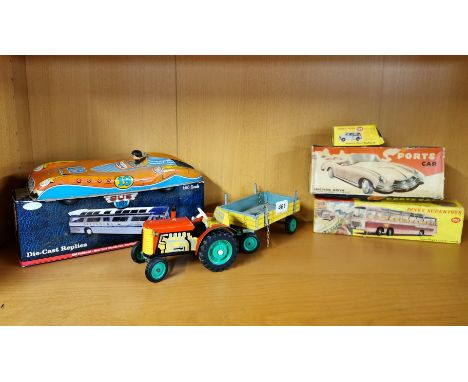A group of vintage tin toys and a Dinkys toys Morris Mini Traveller.
