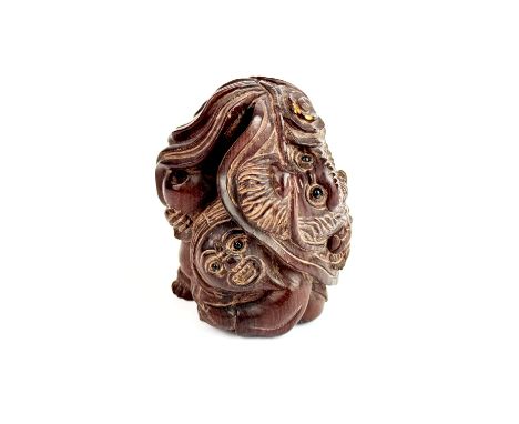 A Japanese carved wooden netsuke, H. 8cm.