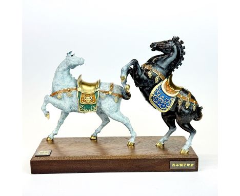 A pair of mounted Chinese enamelled bronze horses, W. 21cm H. 16cm.