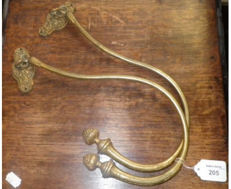 A pair of gilt brass curtain tie-backs