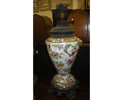 A Victorian oil lamp with Chinese famille-verte body and brass mounts