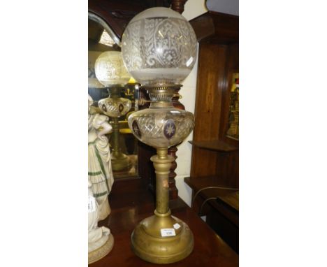 A Victorian brass oil lamp with cut-glass reservoir and original frosted shade 
