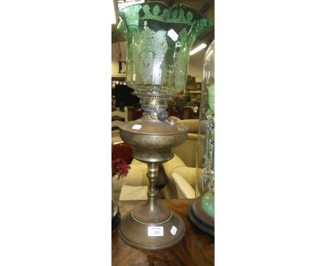 An Edwardian brass oil lamp with original green frosted shade
