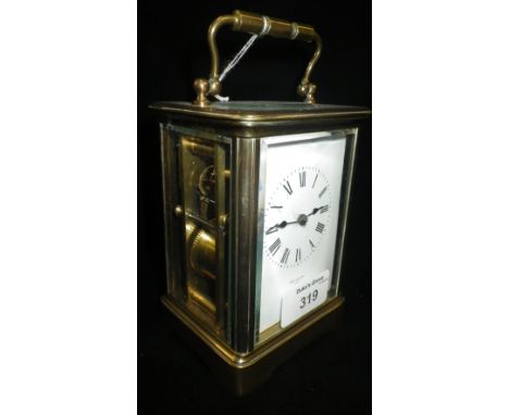 A brass cased carriage clock, the dial marked 'Paris'