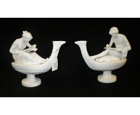 A pair of  Parian figures of ladies reading, on oil lamp shaped bases