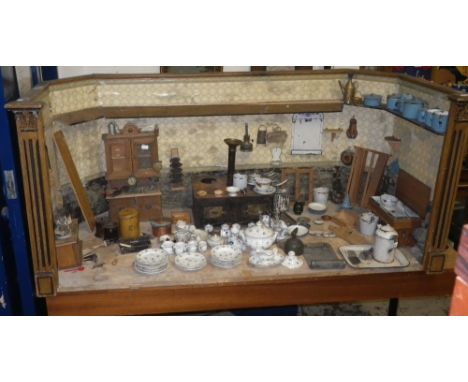 A 19th Century German doll's kitchen with original decorative scheme, the side walls flanked by pilasters, including a large 