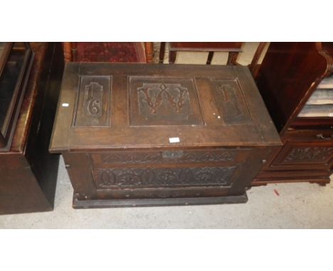 An Edwardian carved oak trunk